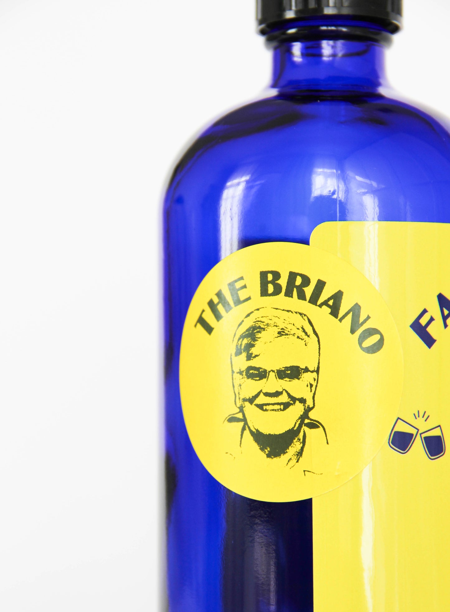 Blue bottle with a yellow label featuring a face and text on a white background